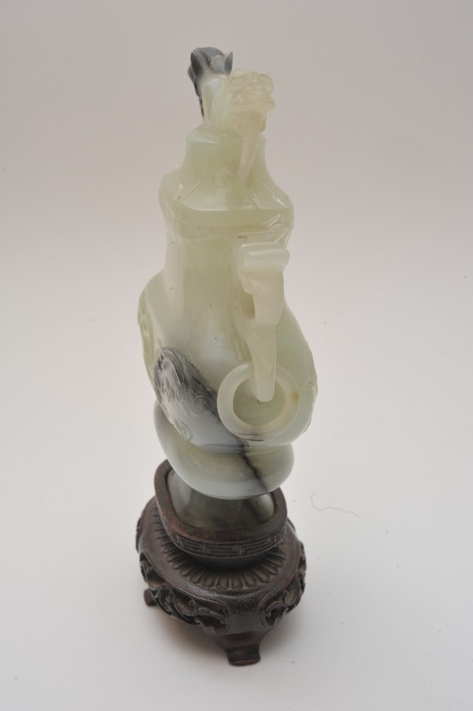 A Chinese carved green hard stone lidded vase, possibly jade, with traces of black impurities with - Image 3 of 4