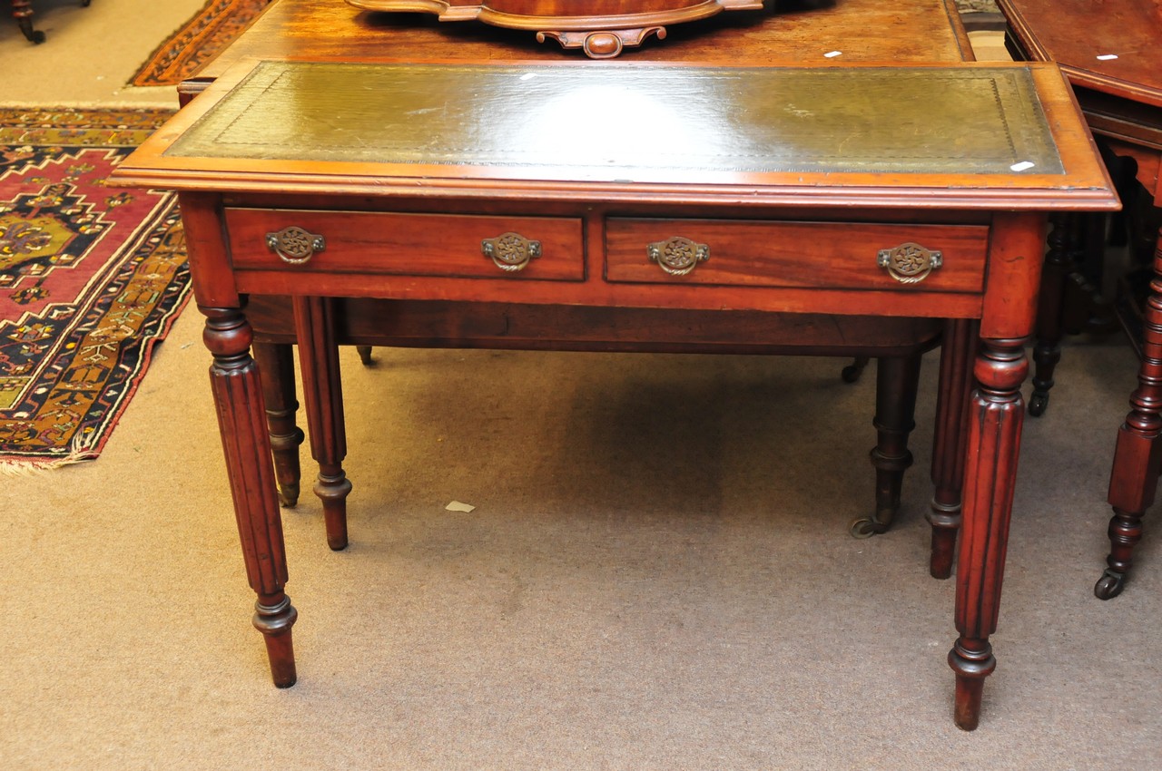 A Victorian writing desk with square tapering fluted legs
