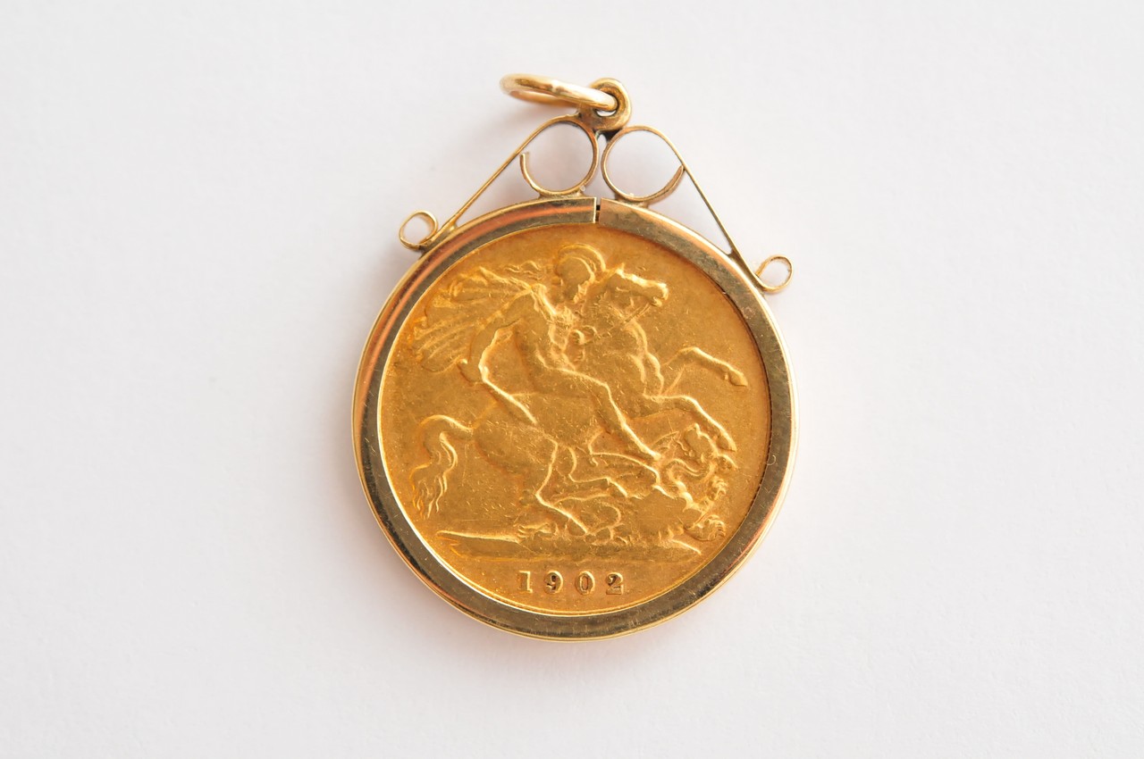 A 1902 gold half sovereign in a pendant bezel mount