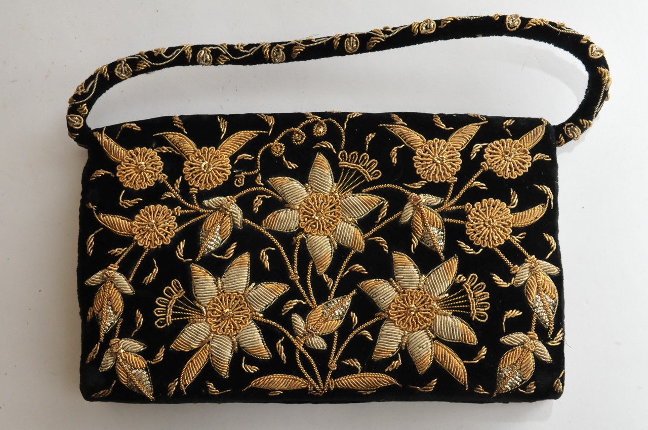A ladies evening bag in black velvet with gilt wirework decoration of flowers and foliage