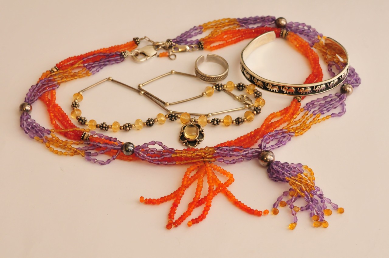 A collection of three ladies silver and gemstone necklaces together with a silver bangle and ring