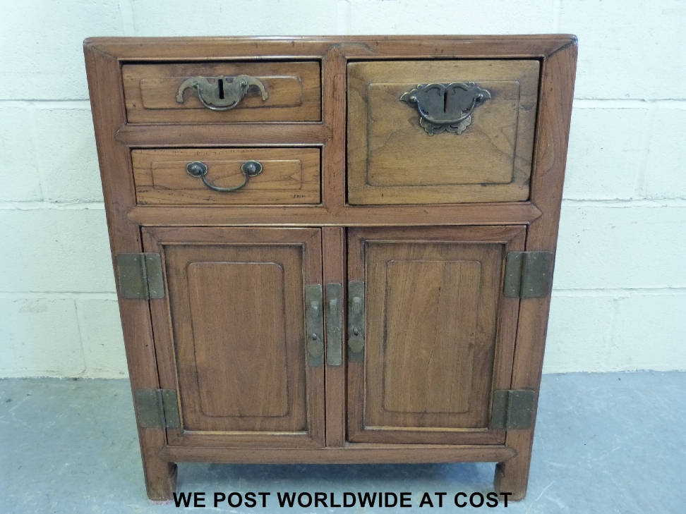 A Chinese elm cabinet with two drawers and a cupboard and two-door cupboard beneath