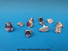 Twelve silver/white metal rings set with various stones to include amethysts and rose quartz