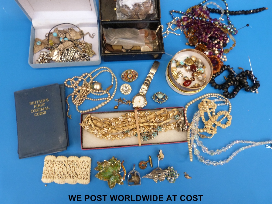 A collection of costume jewellery to include beads, brooches etc together with some coins to include