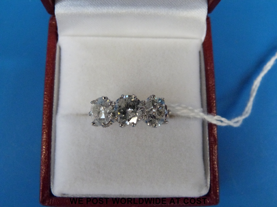 A white metal ring set with three diamonds of 3.3ct approx, marked 18ct