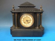 A black slate mantel clock with Romanesque columns to case