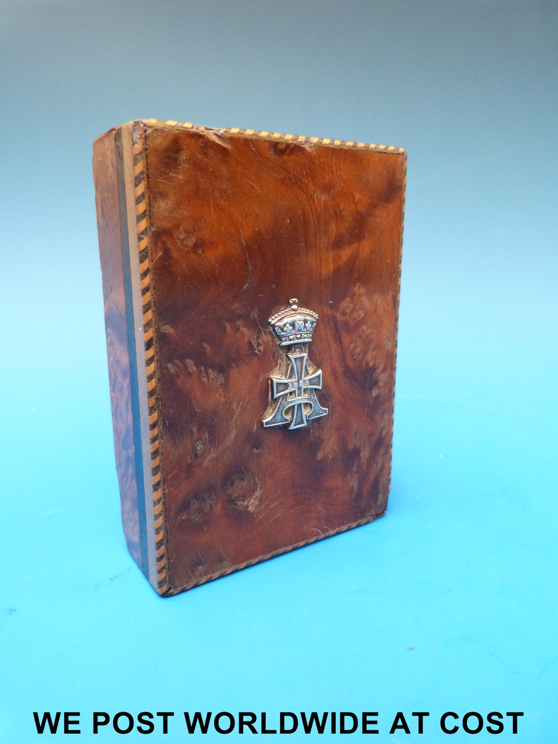 A late 19th century military paperweight, burr walnut and marquetry inlaid, inset with silver
