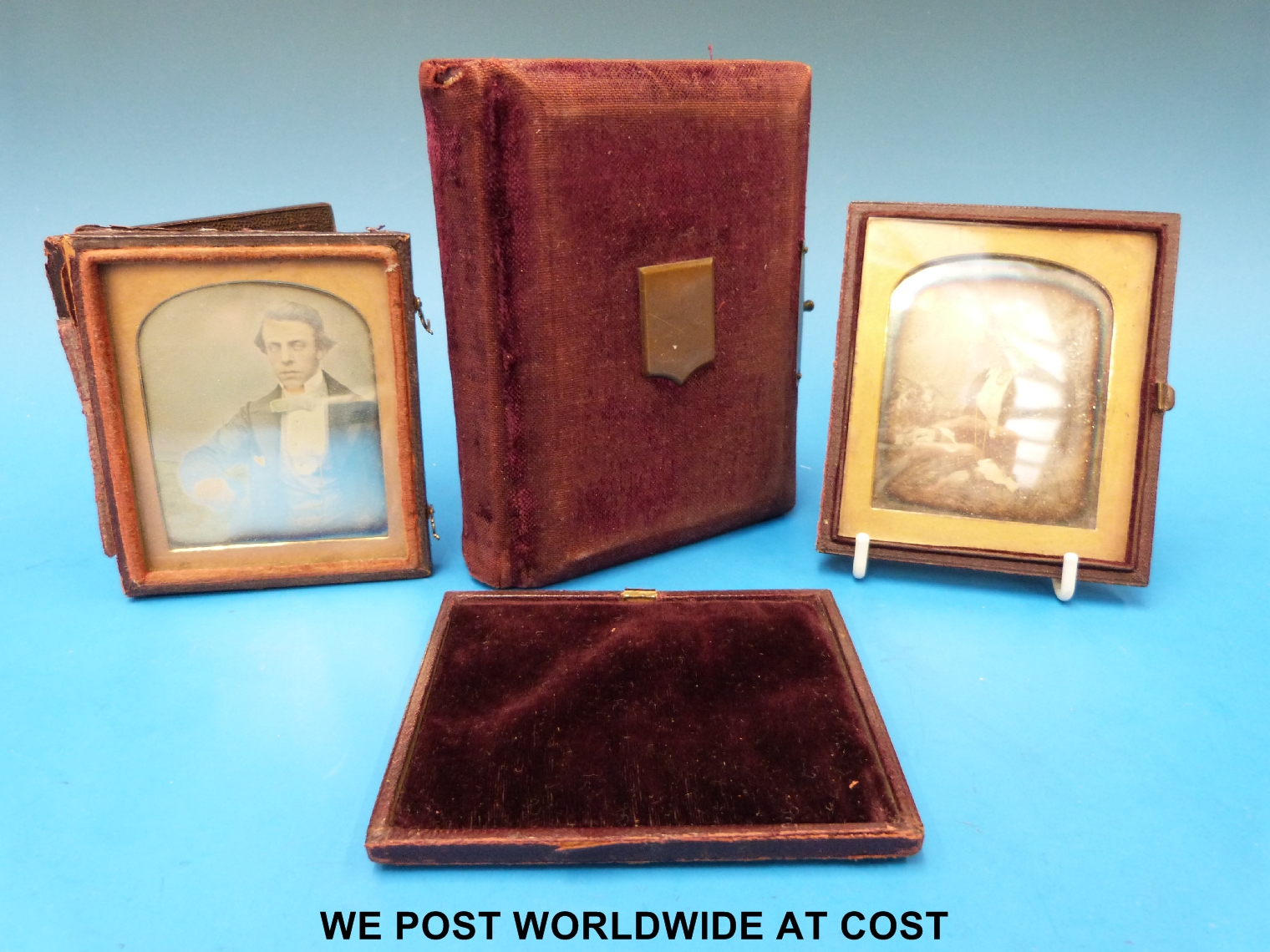 Two cased daguerreotypes together with a small album of photographs