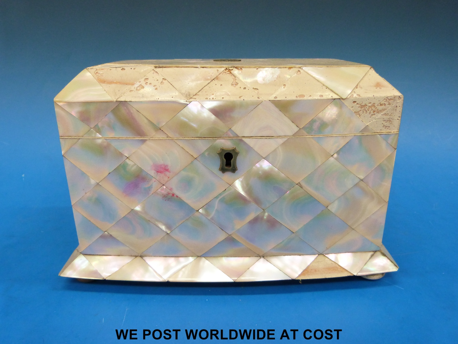 A mother-of-pearl two-division tea caddy with chamfered lid, bow front and flared base, raised on