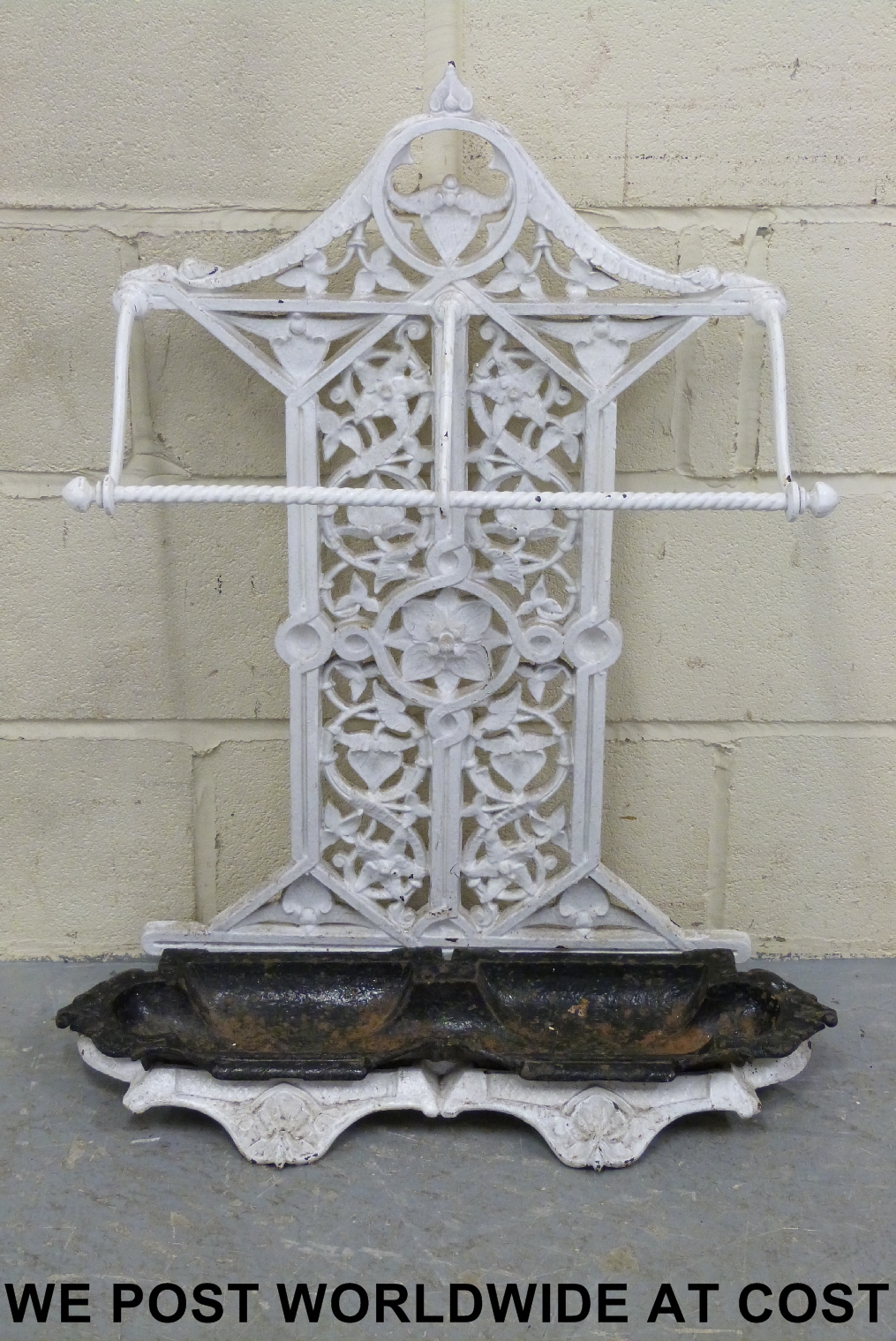 A 19thC cast iron umbrella stand together with a cast iron boot scraper