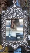 An ebonised and mother of pearl inlaid Moorish/Eastern mirror, 80 x 41 cm