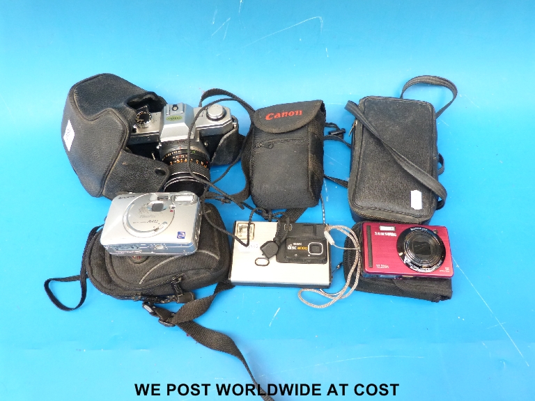 A collection of cameras to include Yashica, Kodak, Canon and a Samsung digital camera.