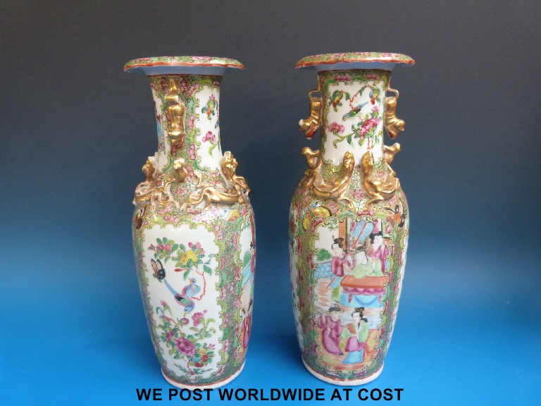 A pair of 19thC Chinese Canton famille rose vases with typical figural decoration