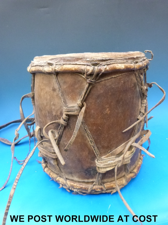 A West African drum with cow hide and leather straps