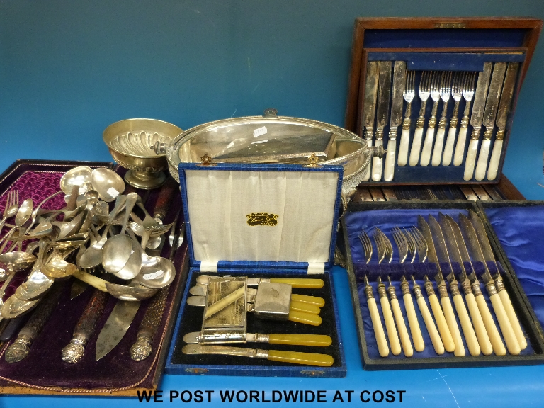 A cased mother of pearl handled dessert set, two other boxed sets of cutlery warming dish and a