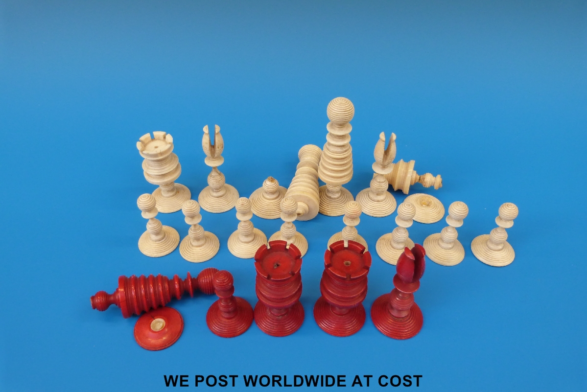A 19thC turned ivory part chess set, comprising 19 pieces in natural and red stained colours, king