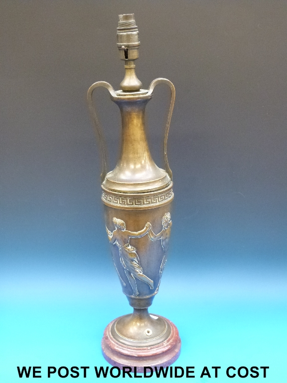 A 19thC bronze  oil lamp converted to electricity and decorated with classical figures 'Dancing with