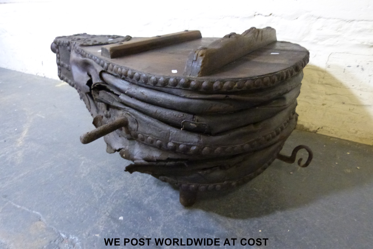 An extremely large set of blacksmith's bellows converted into a coffee table, length 117 cm.