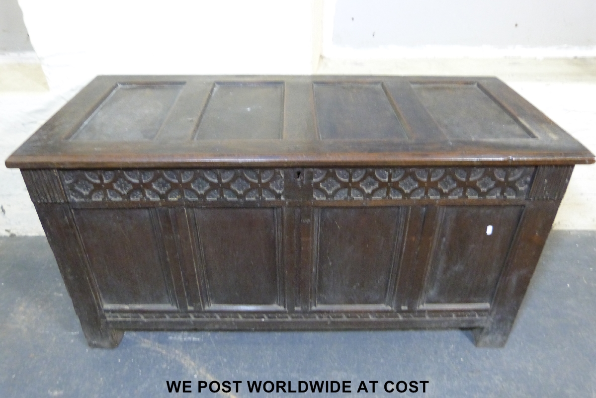 A 19thC panelled oak coffer with carved frieze, width 138 cm x depth 61 cm x height 73 cm.