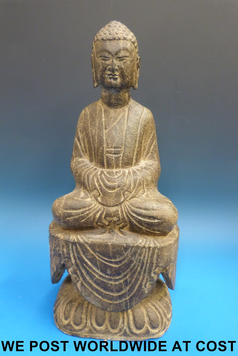 A Chinese stone carving of a seated Buddha