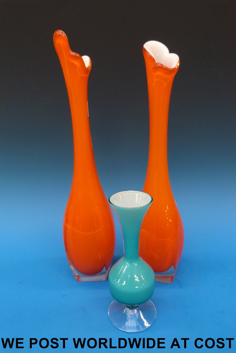 A pair of orange glass stem vases, possibly Murano together with a smaller blue glass vase, possibly
