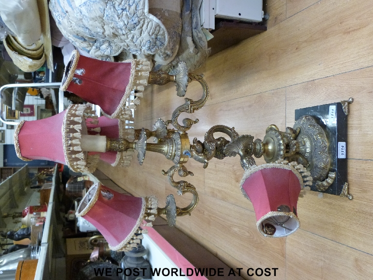 A brassed lamp on marble stand.