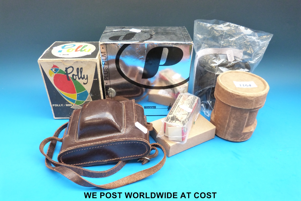 A collection of photography items including a boxed Polaroid camera, 'Polly-Min' tank, Johnsons of