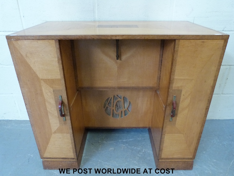 An Art Deco satinwood desk with mahogany cross-banded  edge and each side drawer opening to reveal