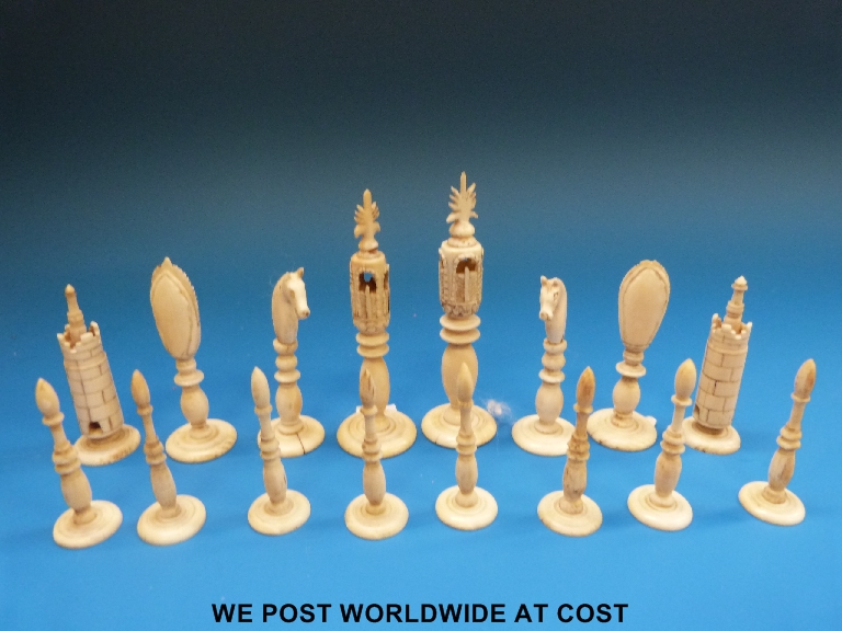 A Indian export ivory chess set, one side stained red the other side left natural, the kings with