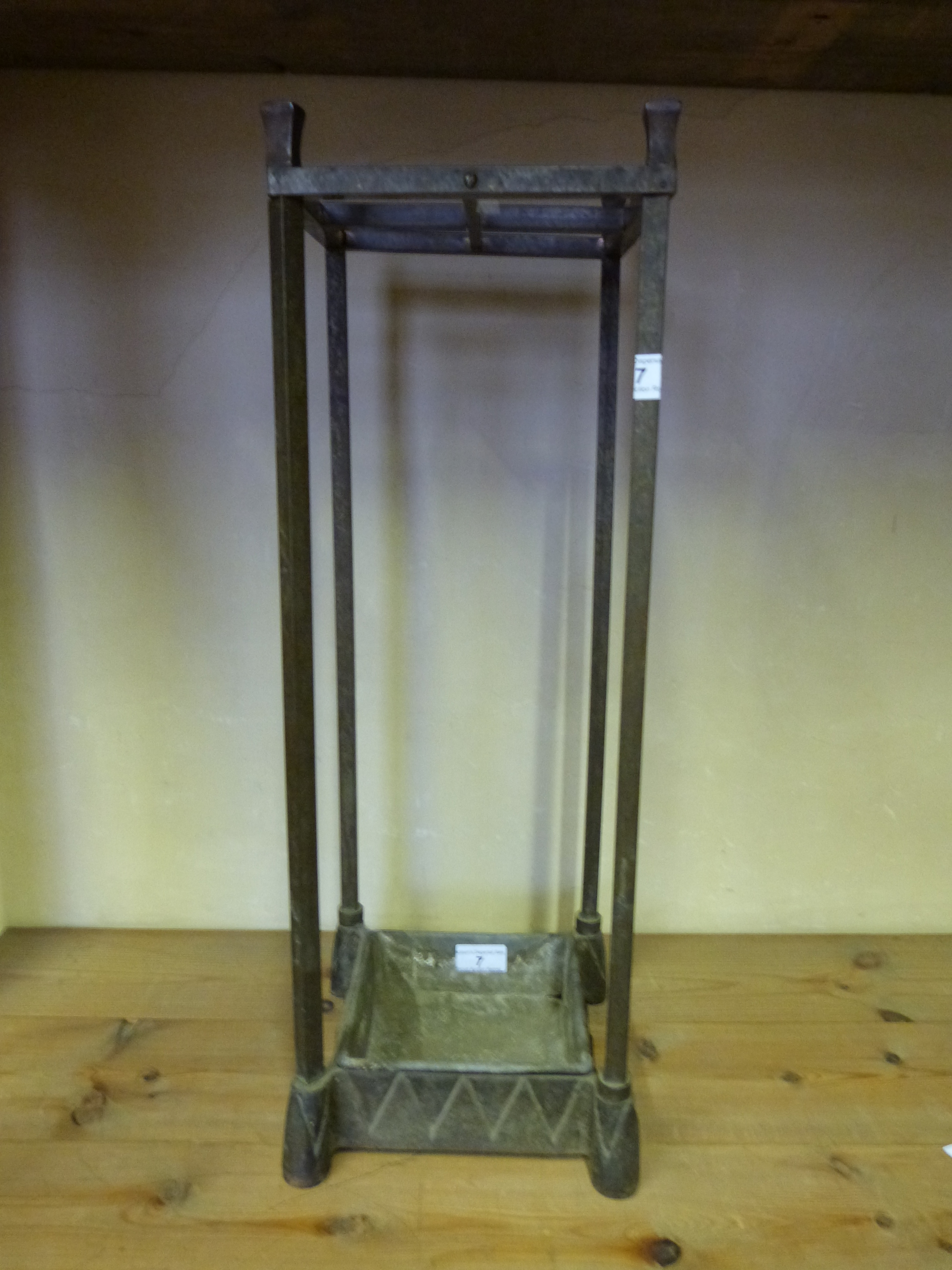 A bronze and cast iron stick or umbrella stand with square supports, height 60cm