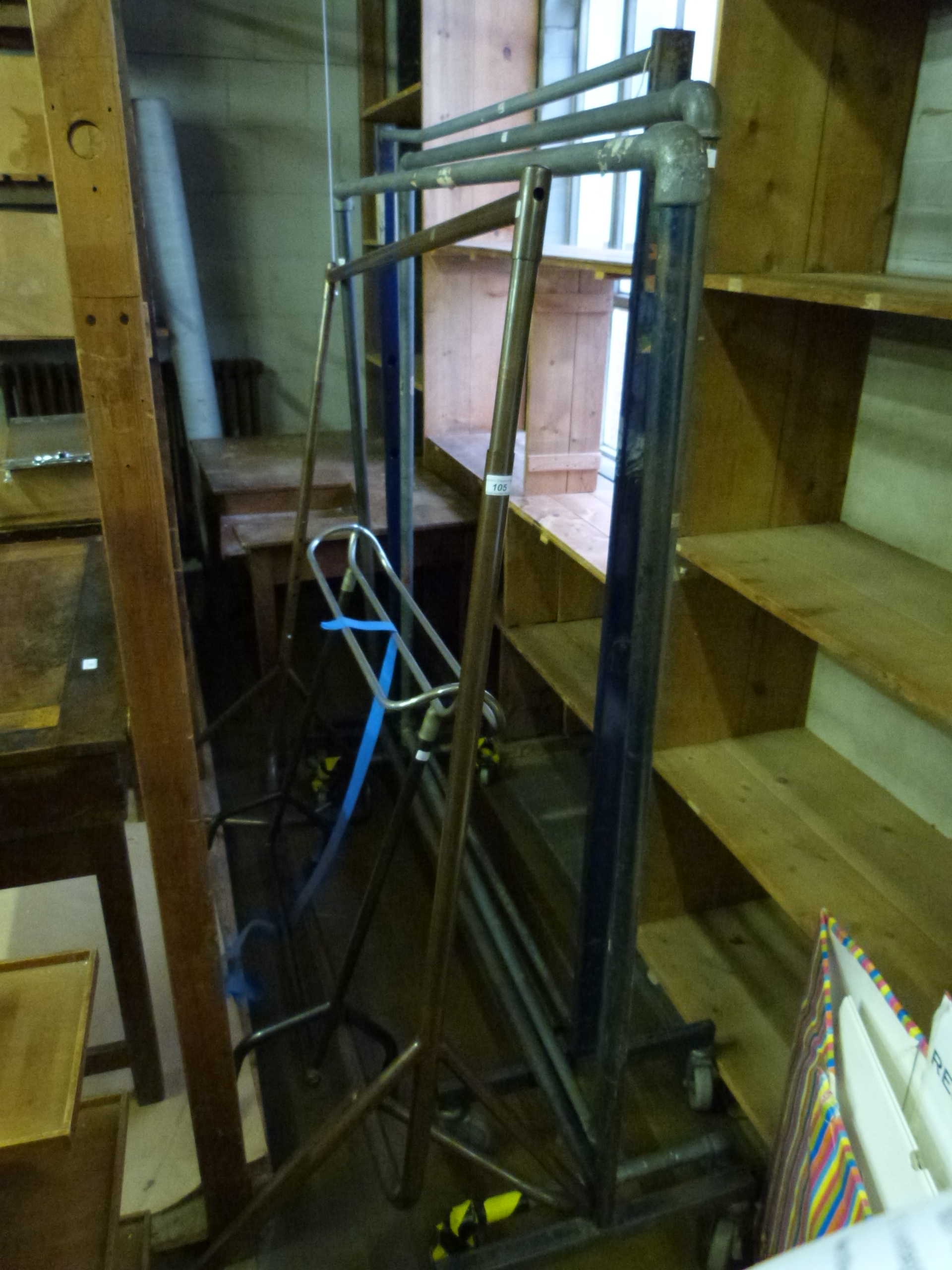 Five various free standing shop type clothes hanging rails together with a bronzed rail for screwing