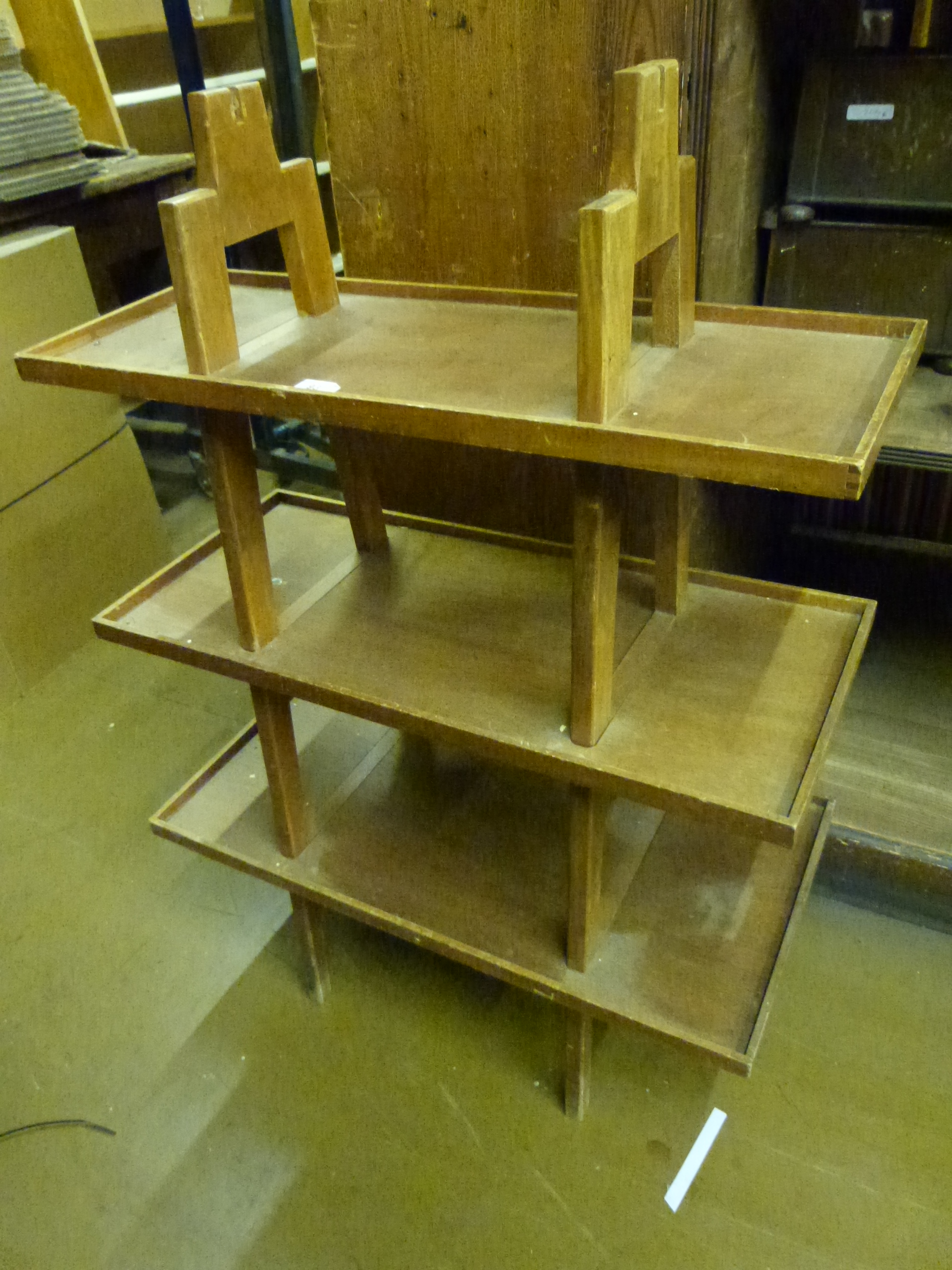 An Art Deco style shop display shelf unit, having three shelves supported on A shaped frames, length