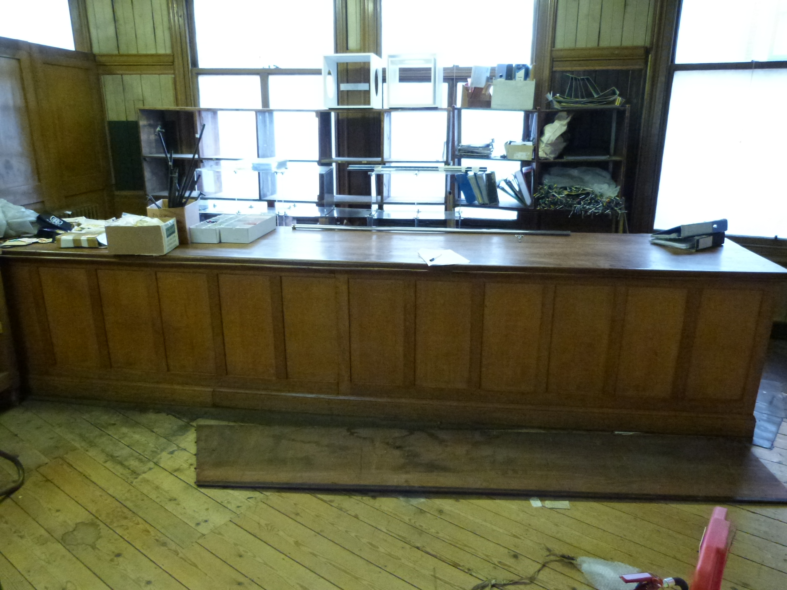 A particularly large tailors workbench or counter table, having two plank possibly elm top, fitted