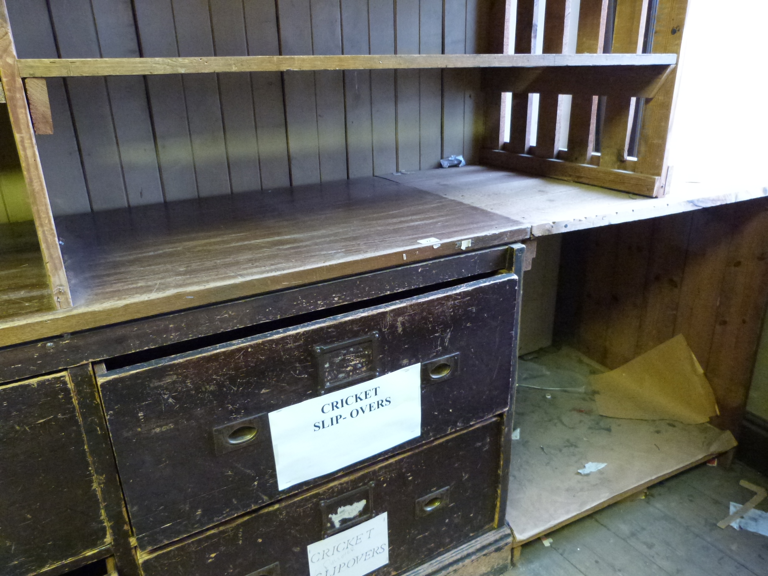 A large eight drawer haberdashery or shop fitting type counter with brass folding handles and