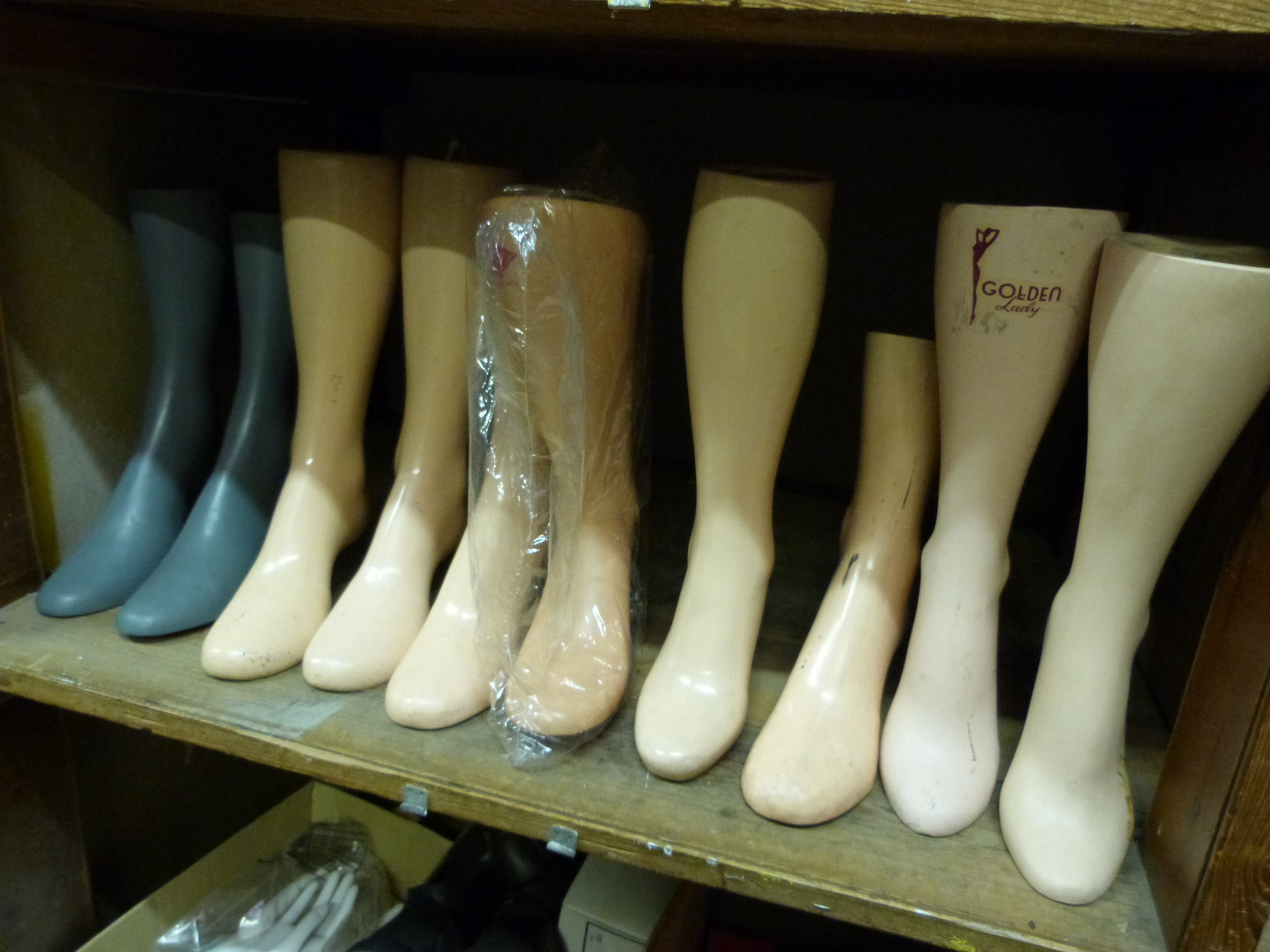 A quantity of shoe display feet together with various ex display shoes