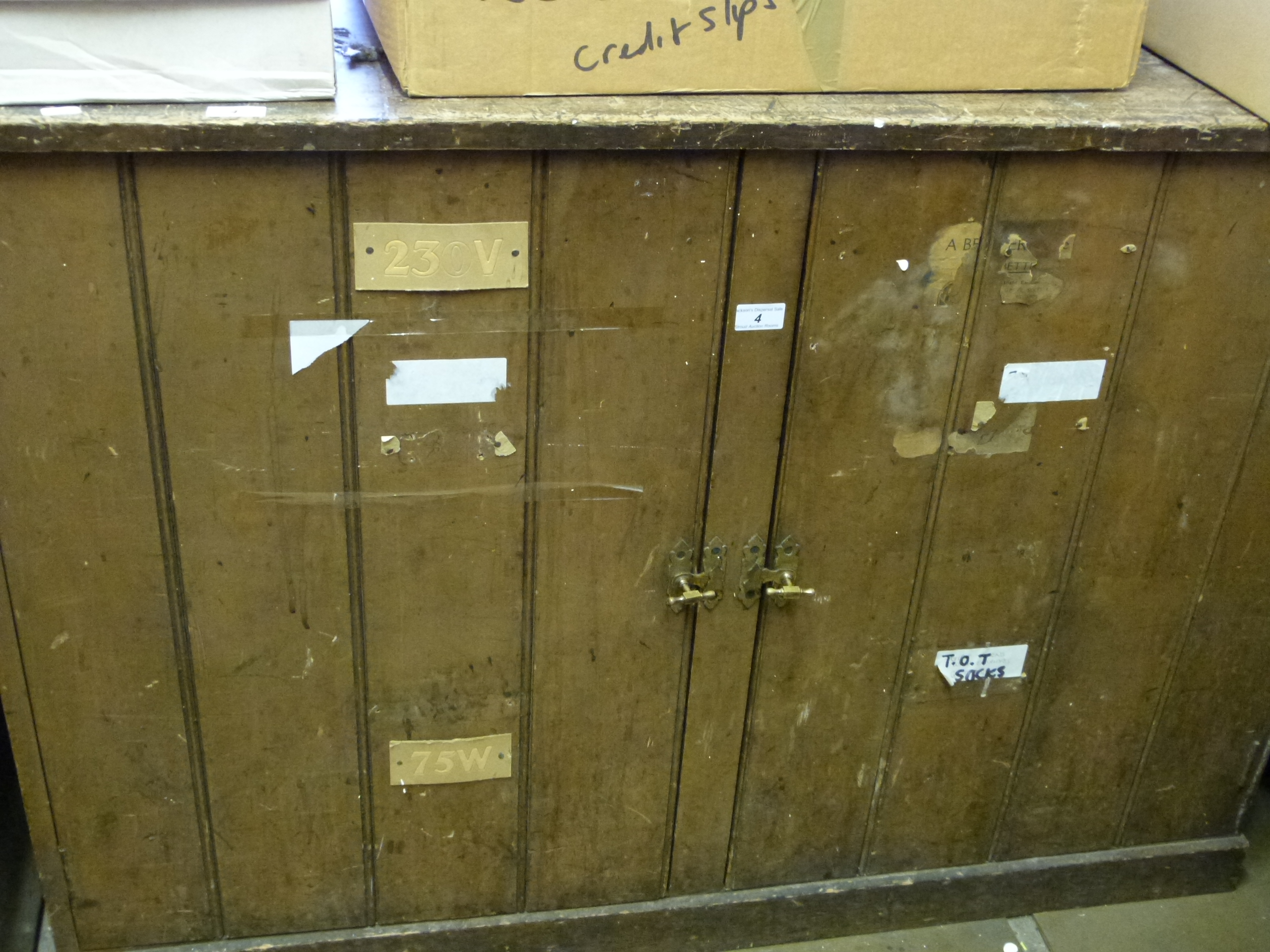 A painted pine cupboard with brass handles, (matching lots 5 and 6, one of which has labels for