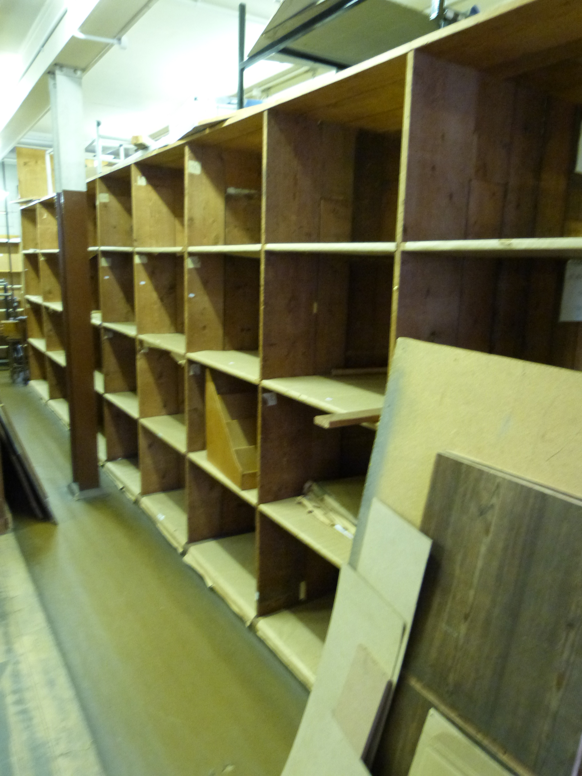 A large double sided pigeon hole or shelf unit, length around 8.5m height approximately 230cm