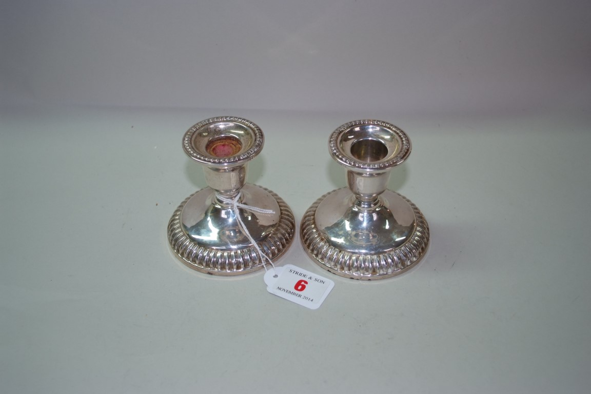 A pair of sterling candlesticks, by 'Birks', weighted, 8cm high.