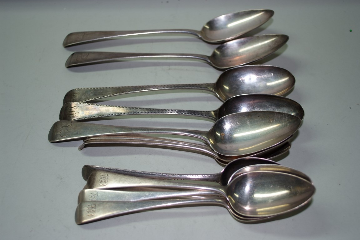 A quantity of Georgian silver Old English pattern dessert and table spoons, 502g.