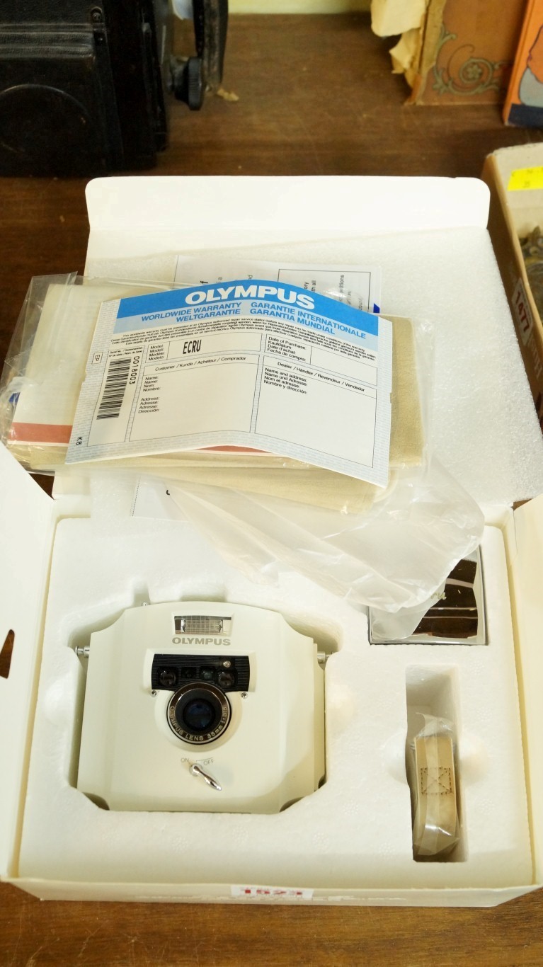 Cameras: an Olympus Ecru 35mm camera, in original box with instructions etc.