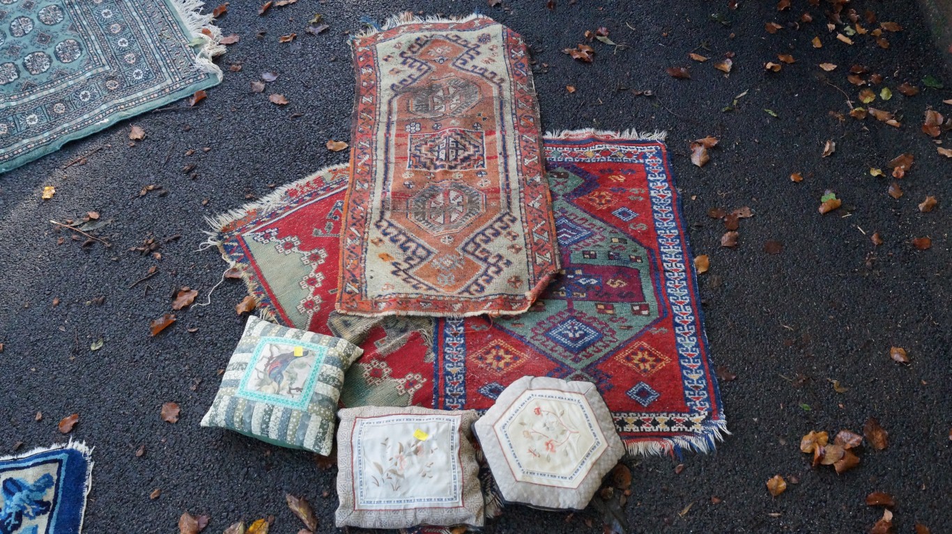Sundry rugs and cushions.