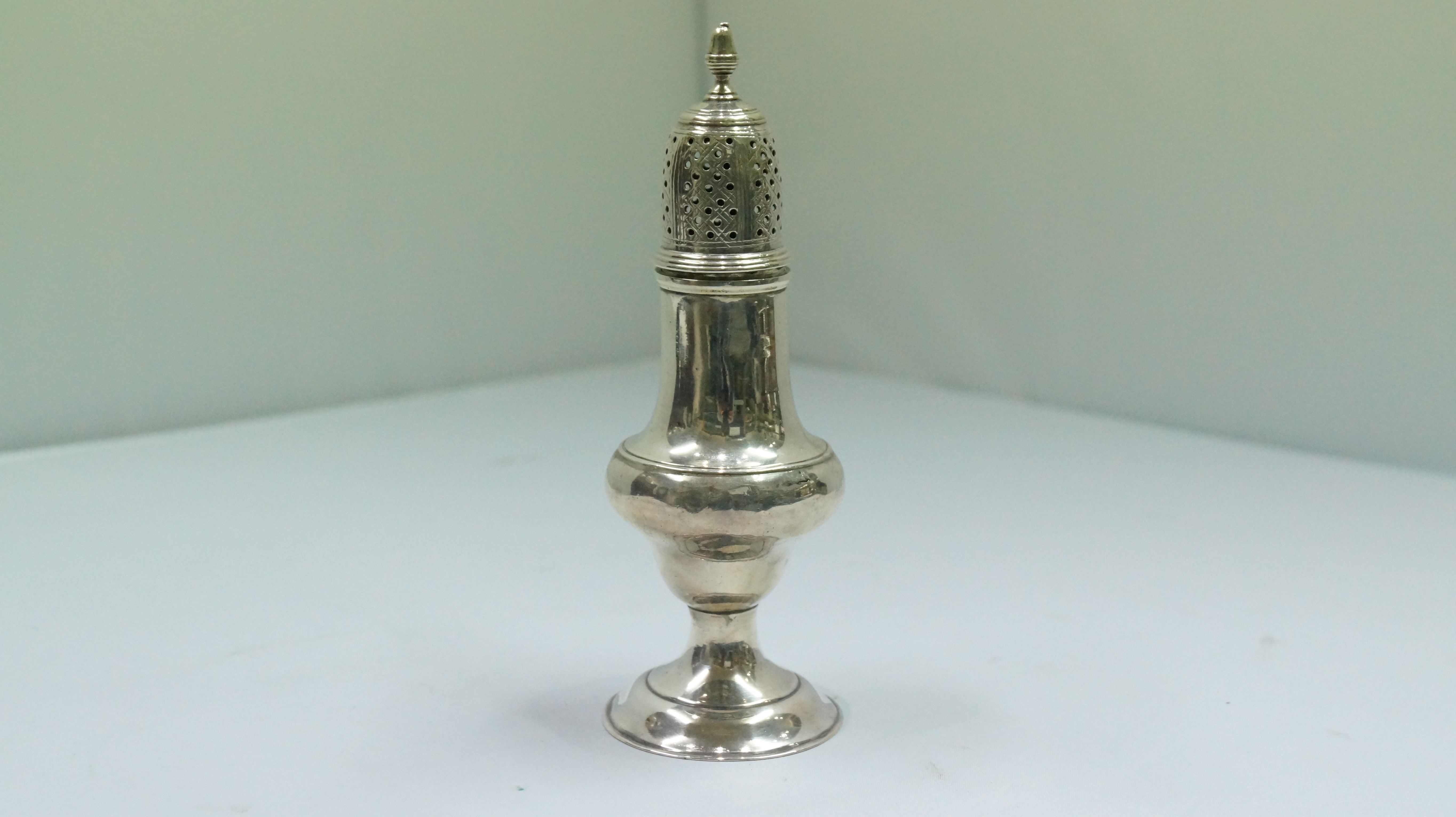 A George III silver baluster sugar caster, by Thomas Shepherd, London 1783, 14.5cm, 74g.   Condition