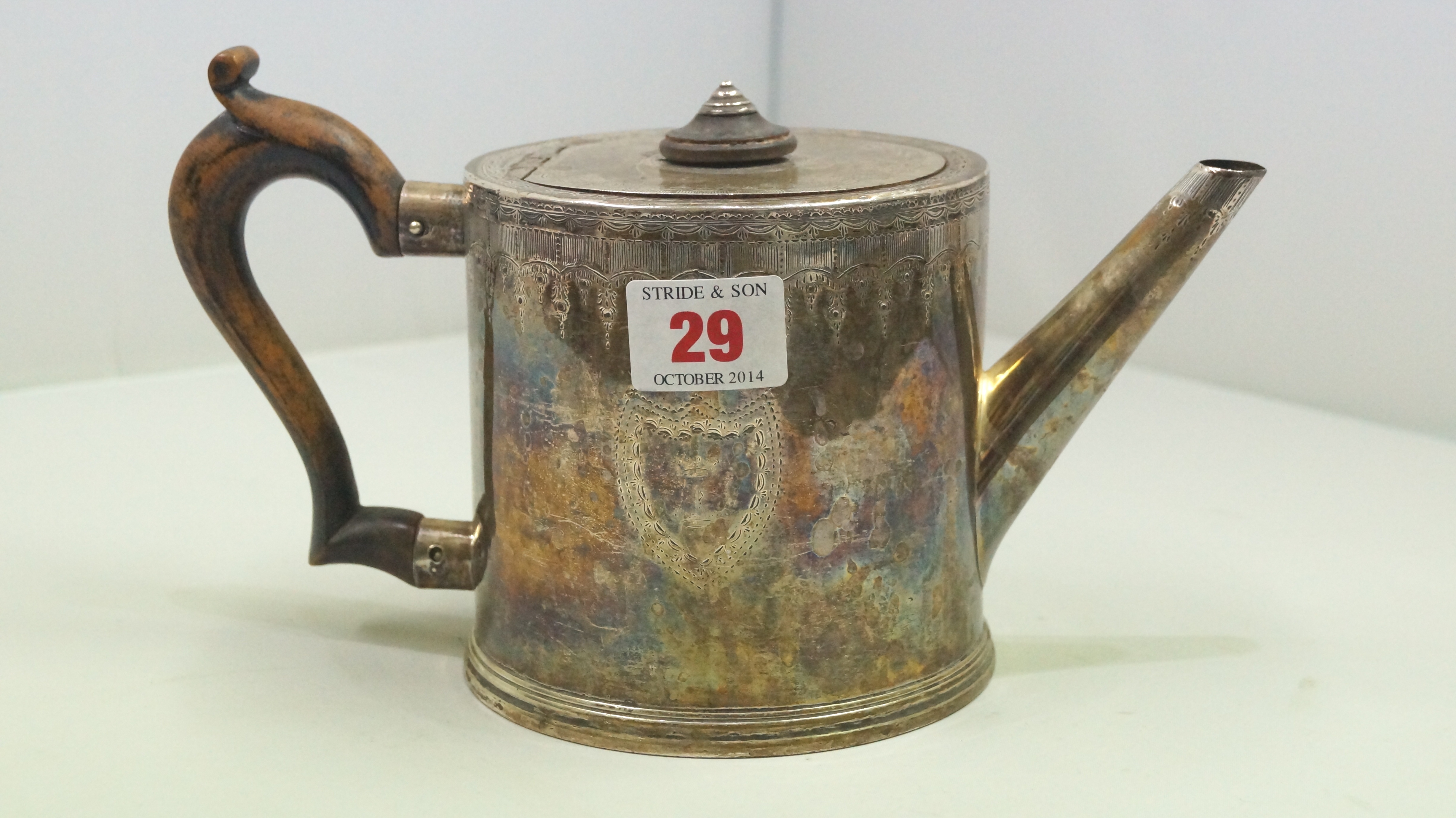A Victorian silver drum teapot, by Hunt & Roskell, London 1851, engraved crests, 11cm, 593g all in.
