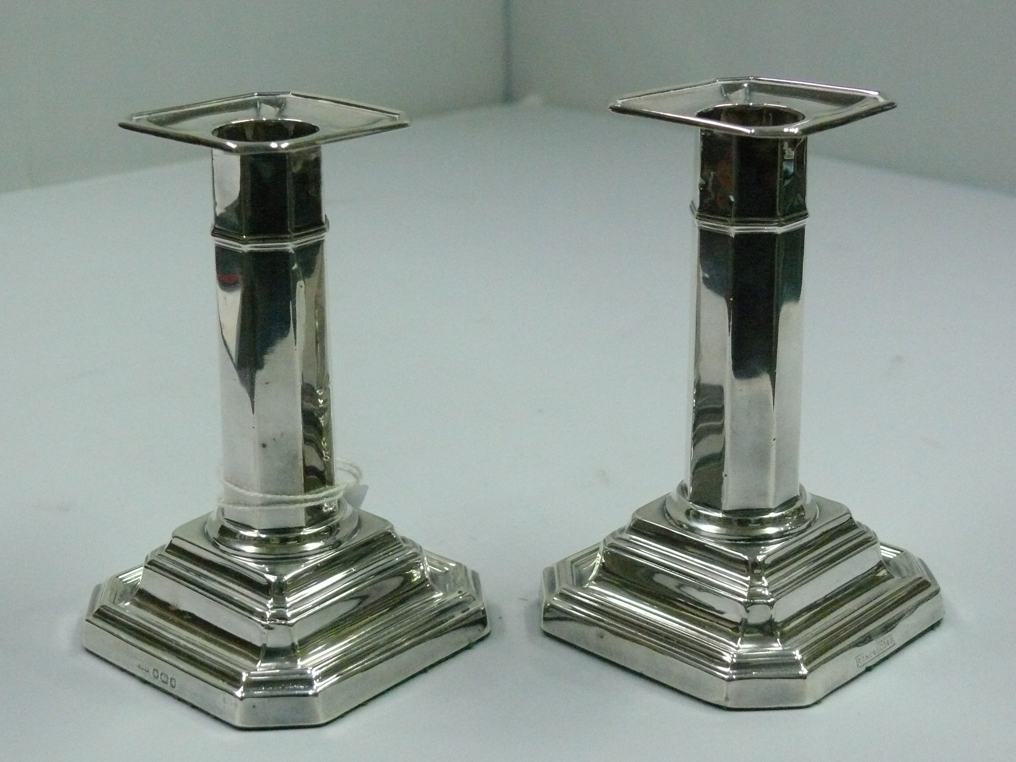 A pair of Edwardian silver octagonal dwarf candlesticks, by J.D & S, Sheffield 1908, weighted, 11.