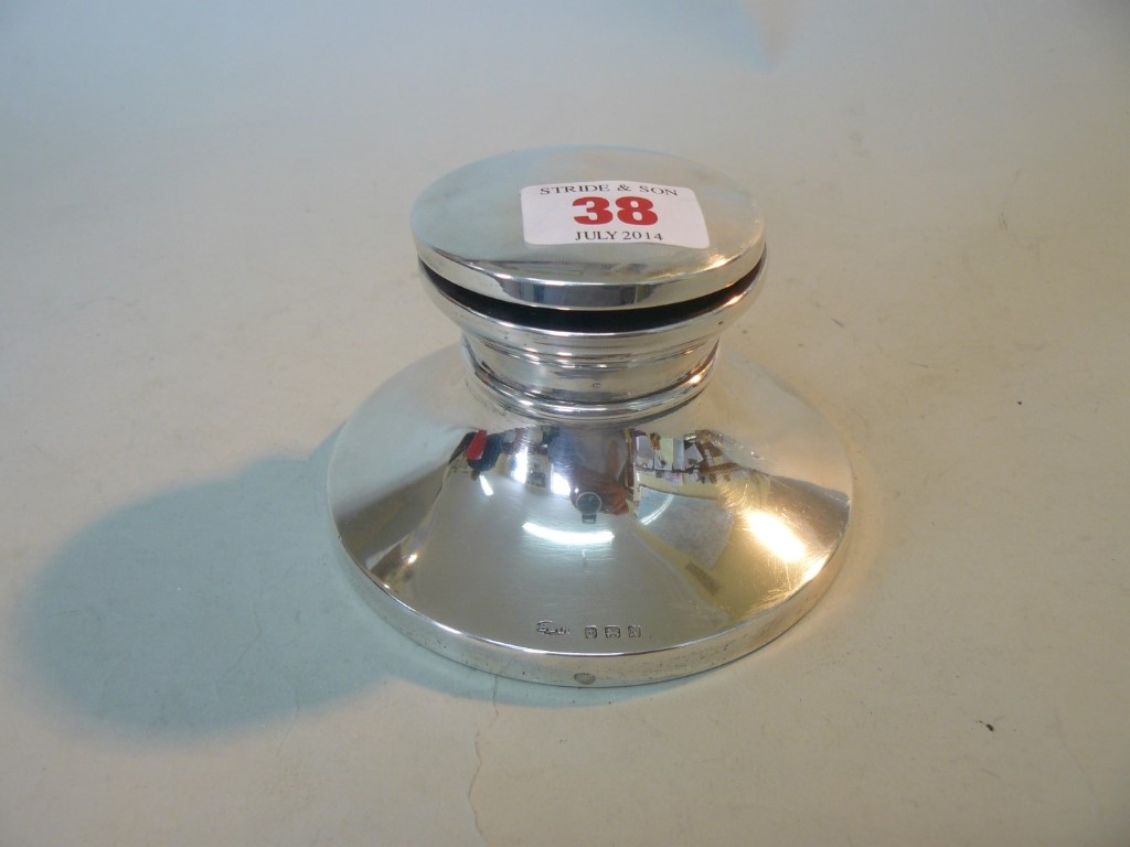 A silver capstan inkwell, by B & Co, Birmingham 1937, 10.8cm diameter, weighted.