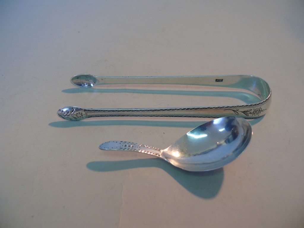 A George III silver brightcut caddy spoon, by Thomas Wallace II, London 1796; together with a pair