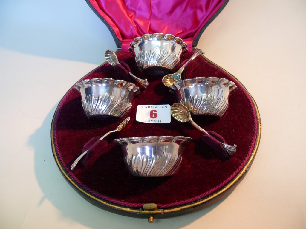 A Victorian cased set of four silver plated salts and salt spoons, by Walker & Hall.