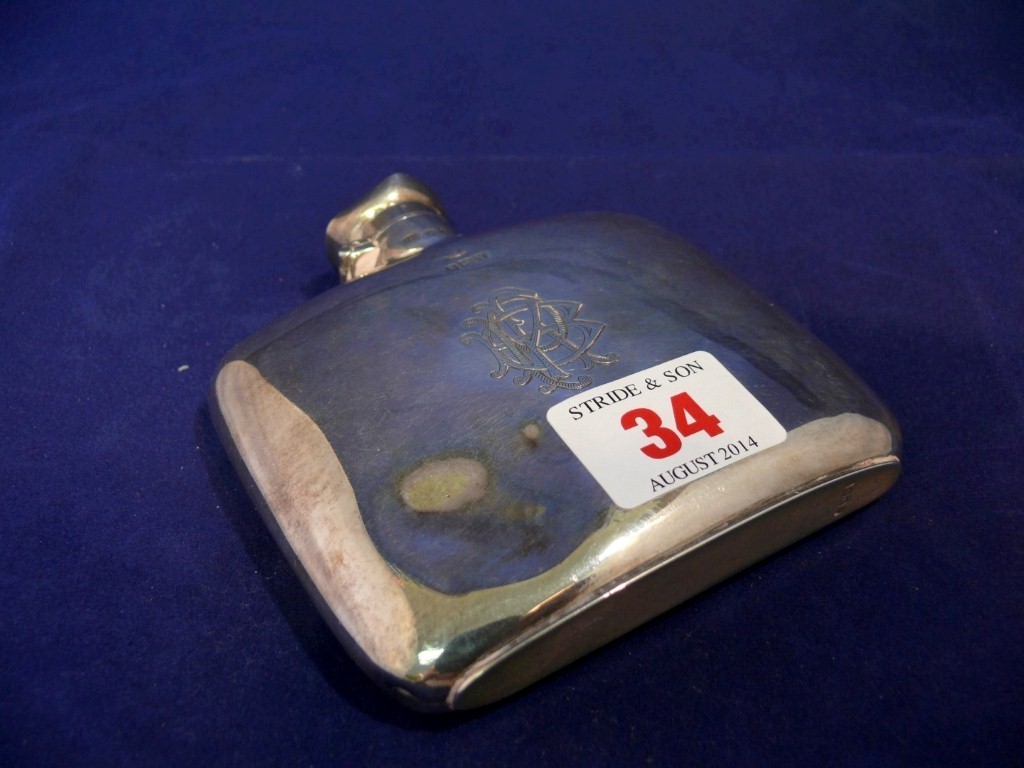 A silver hip flask, by M & B, Birmingham 1920, 137g.   Condition Report:  There is a dent and