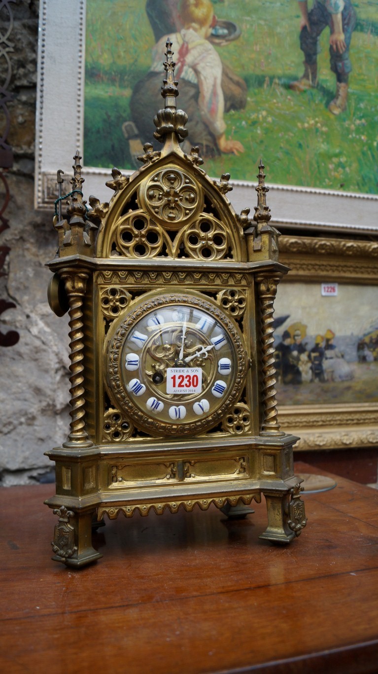 A late 19th century cast brass mantel clock, in the Gothic style, 48cm high.