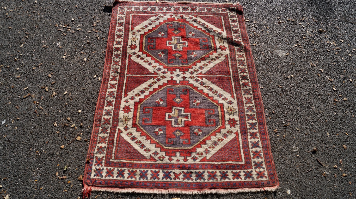 A small geometric rug; and a cream bakhara style rug.